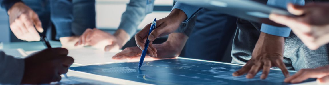 Engineer,,Scientists,And,Developers,Gathered,Around,Illuminated,Conference,Table,In
