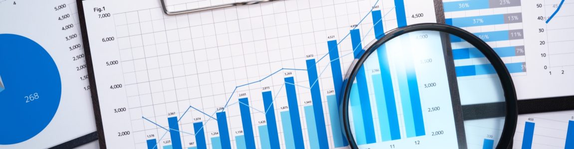 Many business reports and magnifying glass.