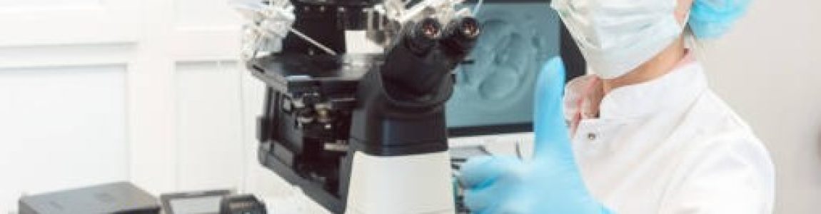 Doctor in fertility lab having just fertilized a human egg with sperm showing thumbs-up